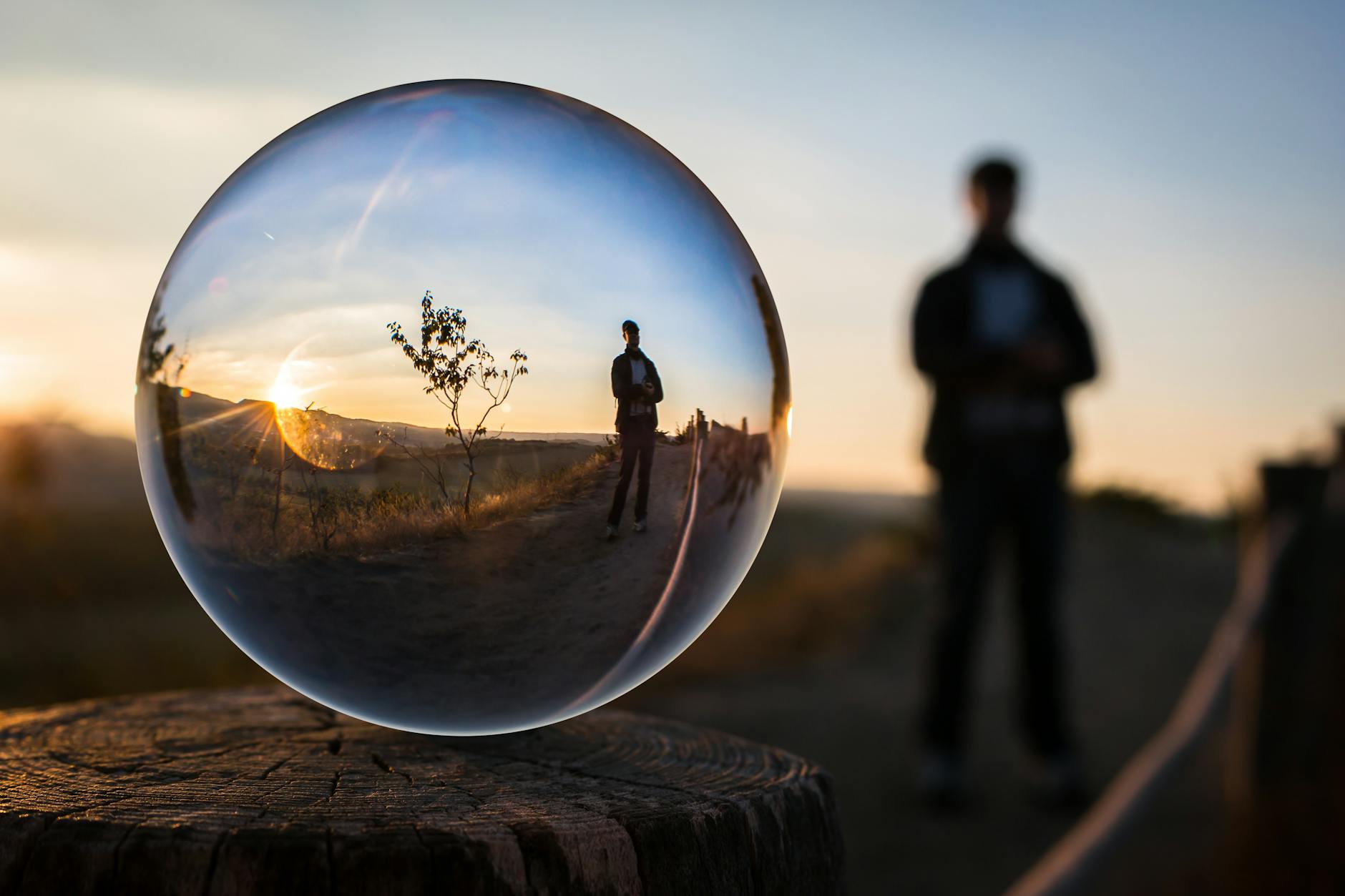 forced perspective selective focus photography of man inside the ball